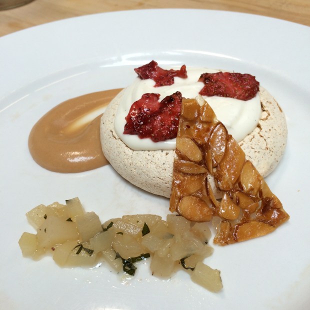 One of the pistachio pavlova's after critique. Roasted strawberries, pastry vanilla cream fill, orange almond nougatine, caramel sauce, and basil pear salad. 