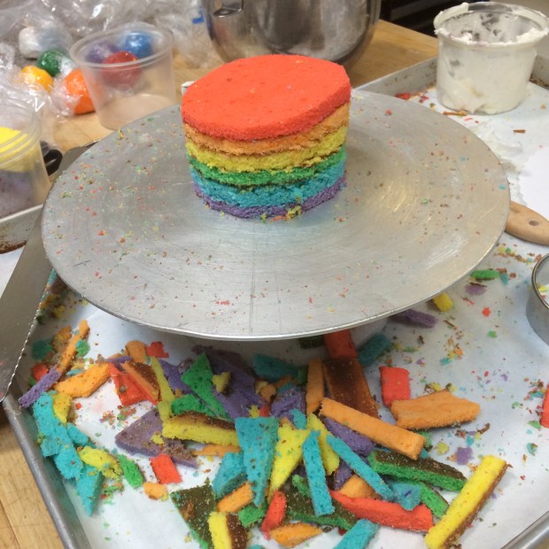 We didn't have a 4" round mold, so we had to carve the top tier manually. I just love the rainbow crumbs everywhere....
