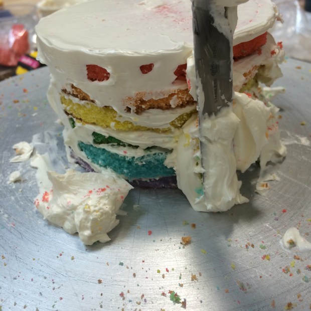 Crumb coating the cakes, to seal in all the crumbs before we add another layer of icing. I love this part.