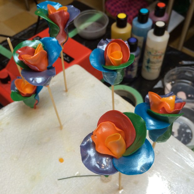 My rainbow roses, these were a decent amount of work to make but I was pleased with the end result.  Made of gumpaste, and the shine is from pearl air brushing.