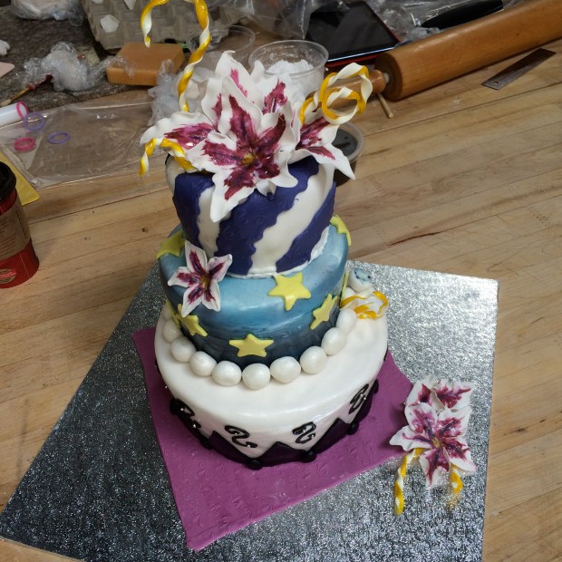 Super fun cake, each tier with a different feel, the top part has sugar curls as well.