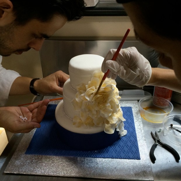 A very cool cake with a dramatic rose draping over each tier. 